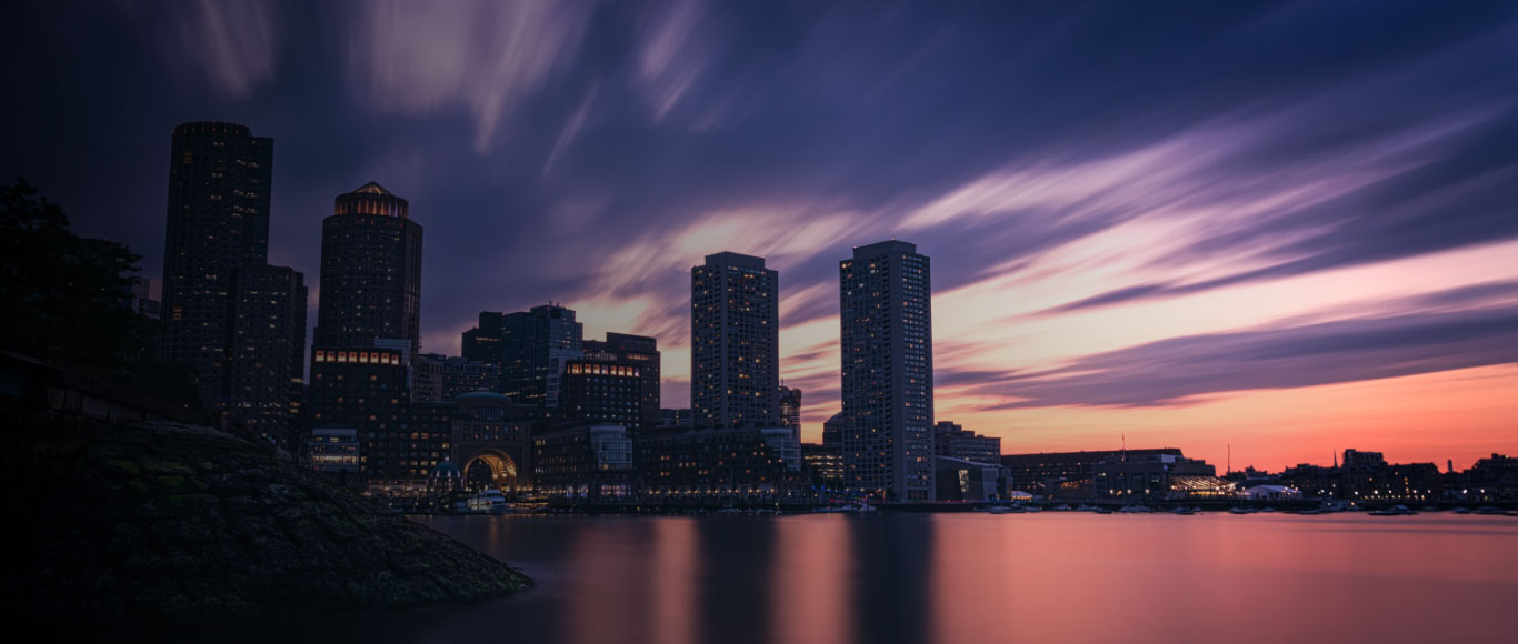contact banner background image showing a sunset and office buildings in Boston